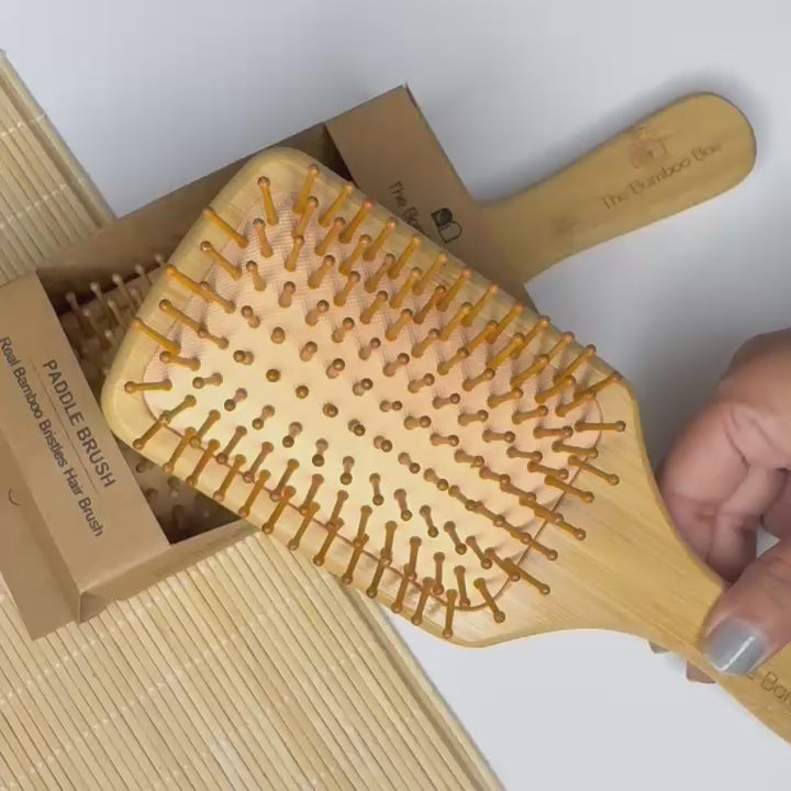 Eco-friendly bamboo paddle hair brush – natural scalp massager for women and men, suitable for all hair types.