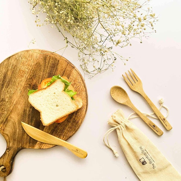 Eco-friendly bamboo cutlery set with spoon, fork, knife, straw, cleaner, and pouch – reusable sustainable dining essentials.