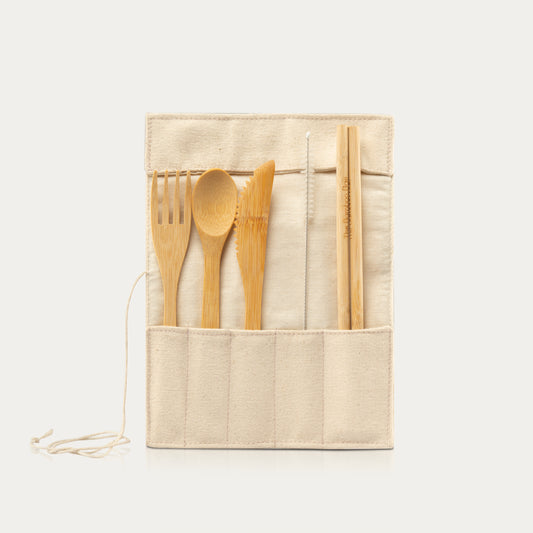A set of bamboo cutlery including a spoon, fork, knife, and straws, presented with a beige cotton canvas pouch and a bamboo cleaner.