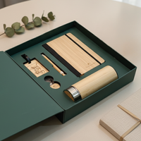 Eco-friendly gift hamper with bamboo diary, bamboo bottle, bamboo pen, and wooden travel tag – sustainable corporate gifting set.