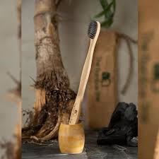 Eco-friendly bamboo toothbrush with charcoal bristles – sustainable oral care alternative to plastic toothbrushes.