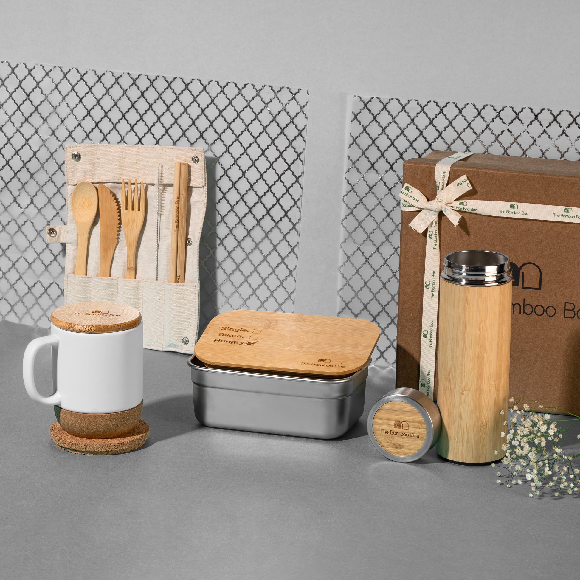 Sustainable gift hamper with bamboo cutlery set, ceramic mug with cork base, bamboo lunch box, bamboo bottle, and round cork coaster – eco-friendly gifting set for daily use.