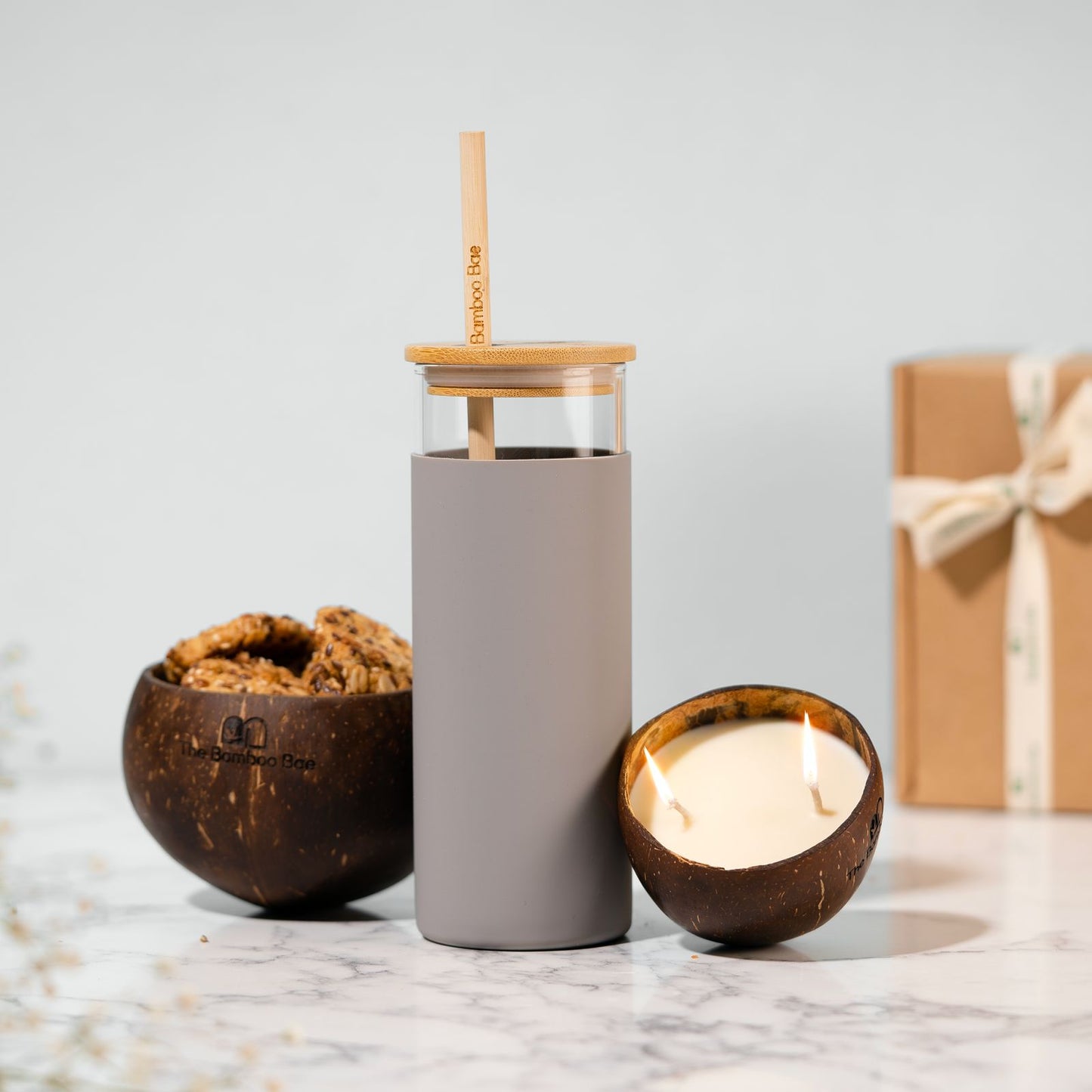 Eco-friendly gift combo with bamboo lid borosilicate sipper, coconut soy candle, and coconut shell bowl – sustainable gifting set.