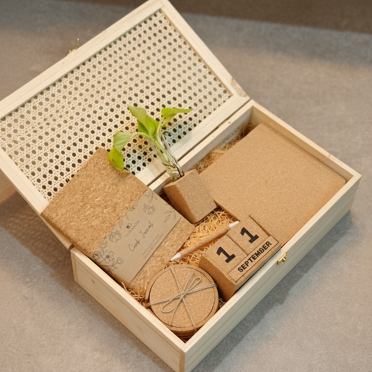 Eco-friendly gift hamper with cork diary, round cork coasters, cork pen, wooden desk calendar, mini plant in cork planter, and cork storage box – perfect for sustainable corporate gifting.