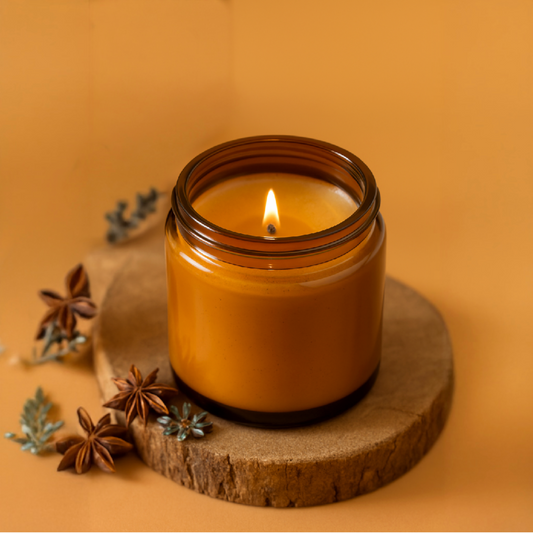 Eco-friendly soy wax candle in reusable amber glass jar – sustainable home décor and gifting option.