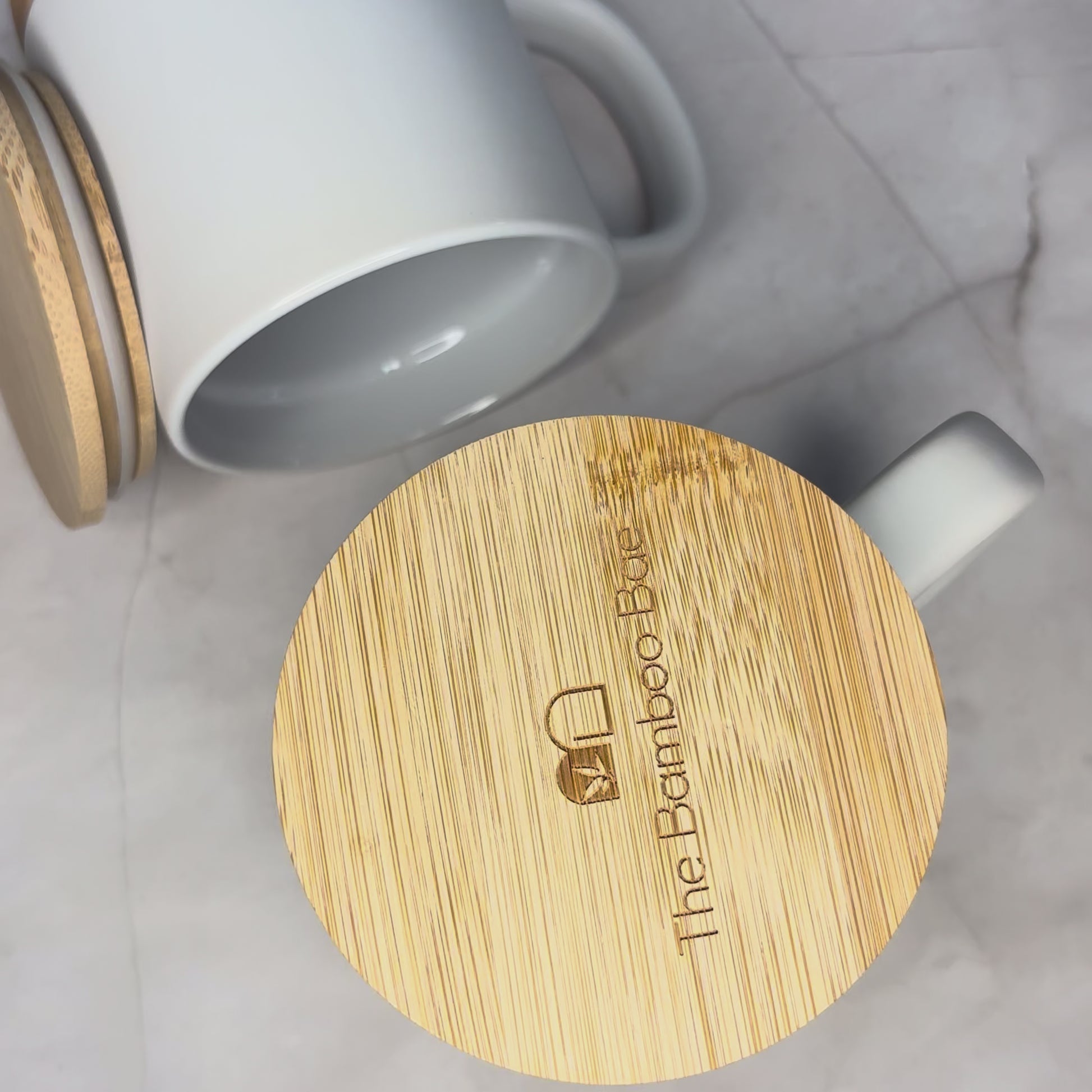 Eco-friendly porcelain coffee mug with cork base and bamboo lid – reusable sustainable drinkware.
