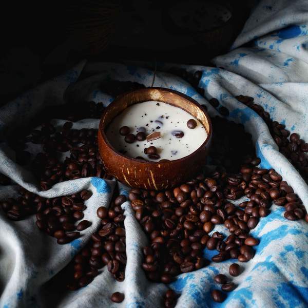 Hand-poured soy wax coffee-scented candle in a coconut shell – eco-friendly sustainable décor and gifting.