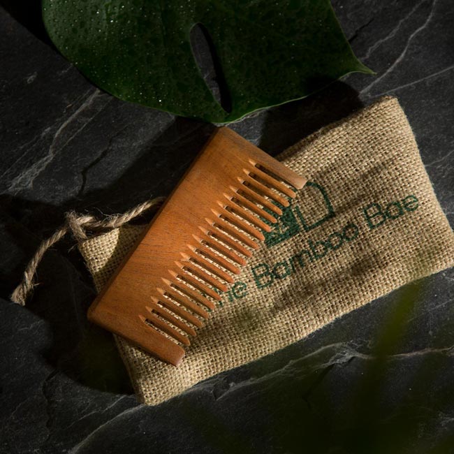 Eco-friendly neem wood comb for detangling hair – natural, anti-static, and gentle on scalp.